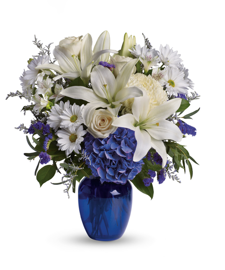 wite flowers in a stunning blue vase